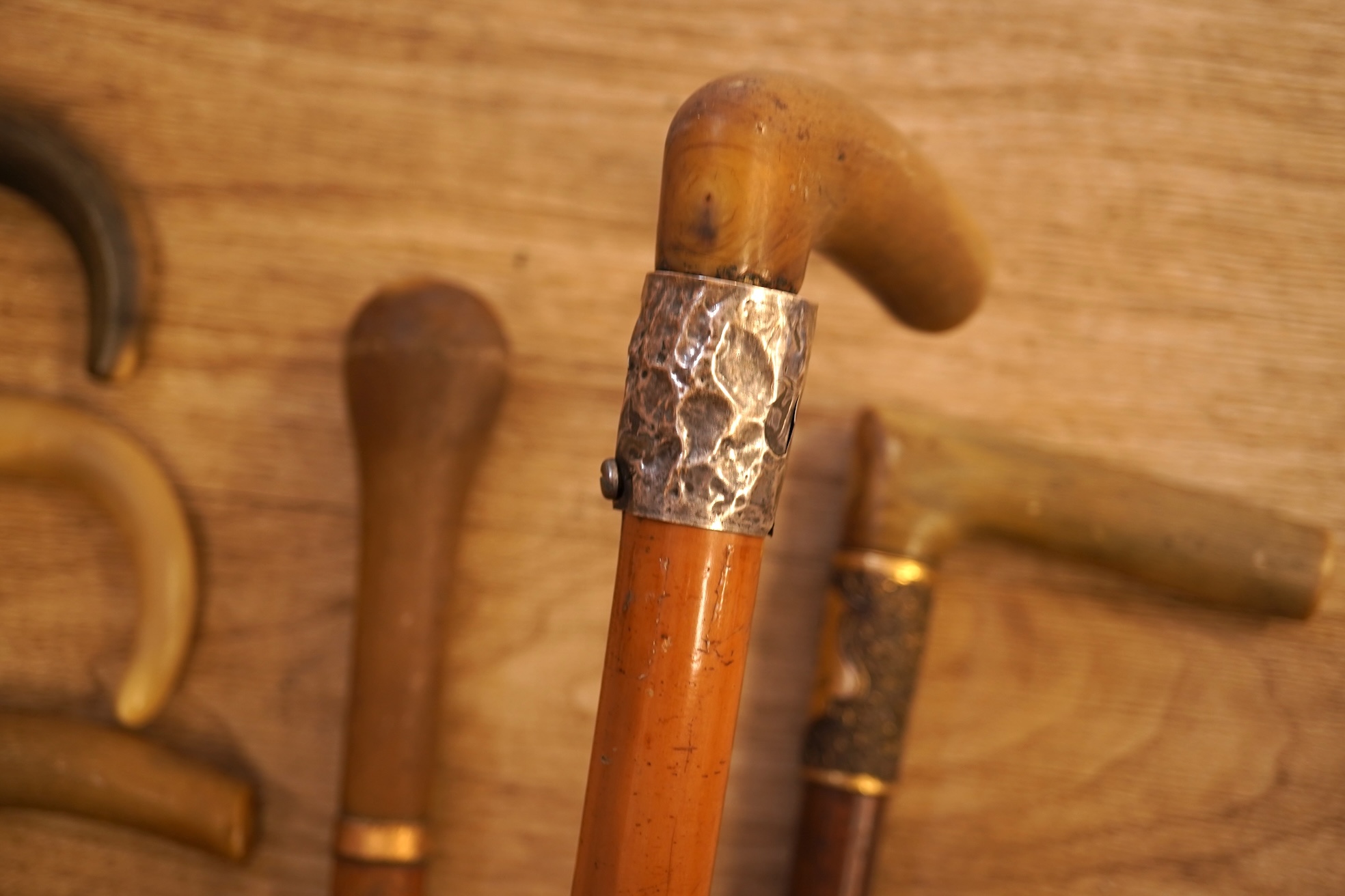 A collection of seven horn handles walking sticks some gold and white metal mounted